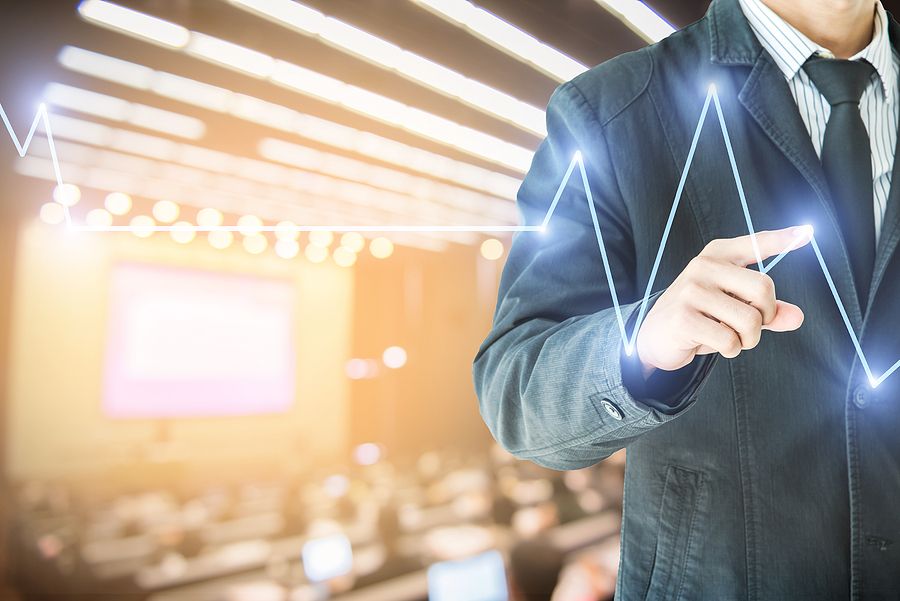 businessman hand touch virtual chart business Abstract blurred of conference hall or seminar room with attendee background double exposure.