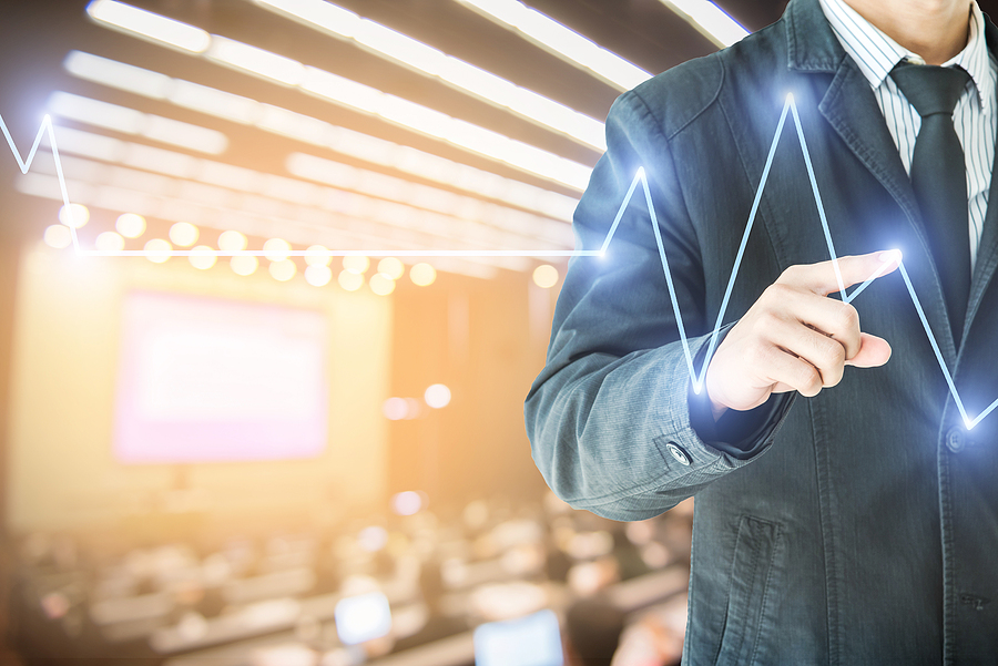 businessman hand touch virtual chart business Abstract blurred of conference hall or seminar room with attendee background double exposure.
